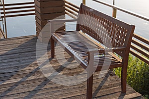 Old wooden bench by the river bank