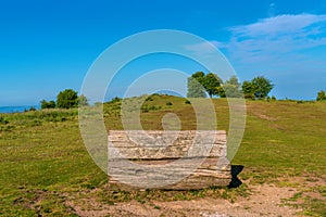 Old wooden bench seat trees Cothelstone Hill The Quantock Hills UK