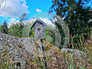 Old wooden bird house in the garden