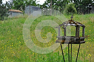 Old wooden birdfeeder on farm