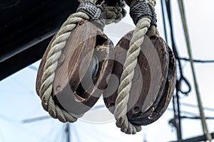 Old wooden block pulleys and rope photo