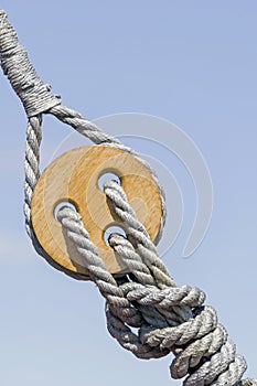 Old wooden block with rope