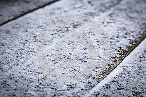 Old wooden board covered with white fresh snow. Christmas winter background