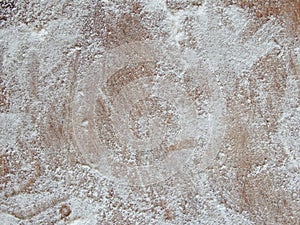 Old wooden board with flour. Background. Photo. Flour over wood