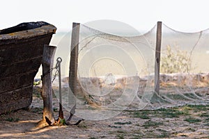 Old wooden boat with anchor and fishing net