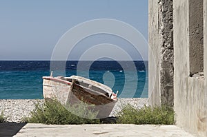 Old wooden boat on the beach in greece on beautiful summer day