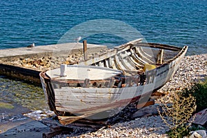 Old wooden boat broken by the sea