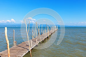 Old wooden boat dock, going far out to sea.