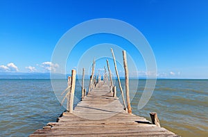 Old wooden boat dock, going far out to sea. photo