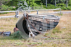 old wooden boat lies on the shore