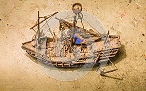 Old wooden boat model on the table.