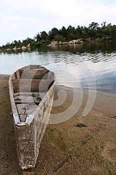 Old wooden boat at river shore