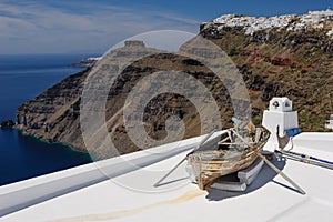 Old wooden boat on roof in Firostefani, Santorini island, Greece