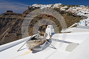 Old wooden boat on roof in Firostefani, Santorini island, Greece