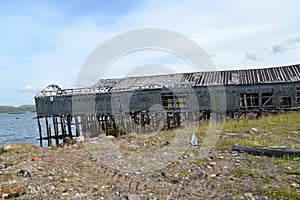 Old wooden boat shed in the settlement of Teriberka on the bank of the Barents Sea