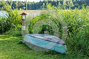 Old wooden boat stored on the lakes shore