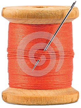 Old wooden bobbin with red thread isolated photo