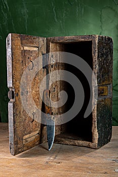 Old wooden box and old knife. Vintage tool. Homemade box and knife