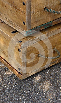 Old wooden boxes with rope handles on street