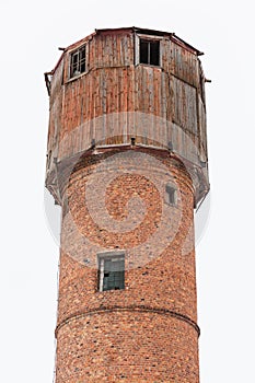 An old wooden and brick water firestation orange rural tower. Isolated on a clear white sky background