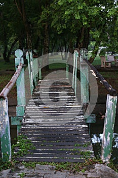 Old wooden bridge across canal in autumn