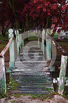 Old wooden bridge across canal in fall