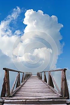 Old wooden bridge, blue sky and white clouds