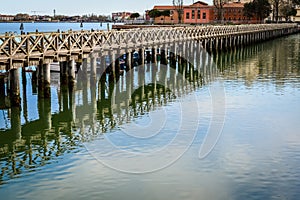 Old wooden bridge in Chioggia`s harbor