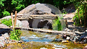 Old wooden bridge and a flow river