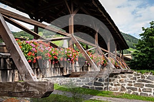 Old wooden bridge with flowers in Matrei in Osttirol