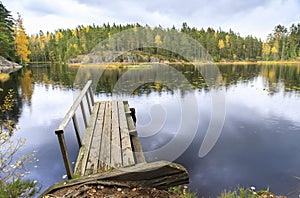 Old wooden bridge in a lake in autumn