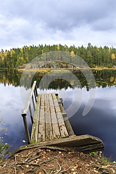 Old wooden bridge in a lake in autumn