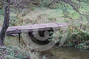 Old wooden bridge over a river, autumn, reflection