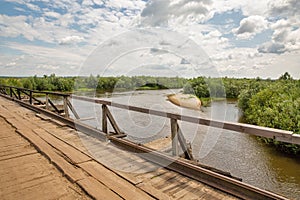 Old wooden bridge over Sluch river in Rivne region, Ukraine