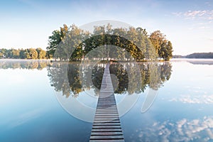 Old wooden bridge in park. Beautiful colored trees with lake in autumn, landscape photography. Summer and Late autumn. Outdoor and