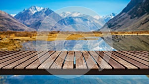 Old wooden bridge on the reflection of Blur snow mountains