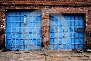 Old Wooden Bright Blue Garage Doors Abaondoned Brick Building