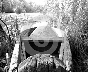 Old wooden broken boat for swimming on banks water in natural reeds