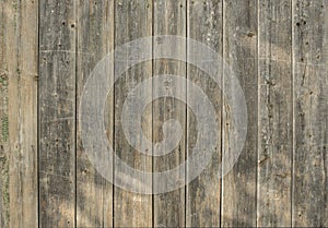 Old wooden brown fence for background from boards of different widths
