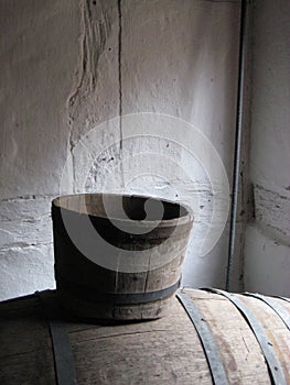 Old wooden buckets in whitewashed timber framed house serene light