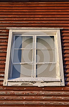 Old wooden building window with frozen glass