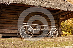 Old wooden cart in front of an old barn. Rural landscape