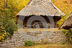 Old wooden cart in front of an old barn. Rural landscape