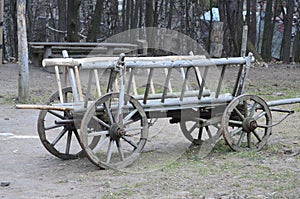 Old wooden cart in front of an old barn. Rural landscape