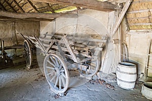 Old wooden cart inside barn