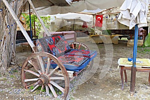 Old wooden cart as a soft chair at a table in the courtyard of the Turkish yard
