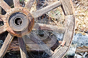 Old wooden cart wheel. The concept of outdated technologies, ecotourism