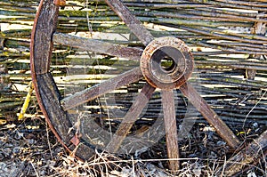 Old wooden cart wheel. The concept of outdated technologies, ecotourism