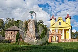 Old wooden catholic Trinity Church and bell tower in Daniushevo, Grodno region, Belarus