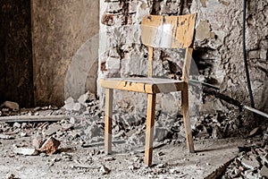 Old wooden chair in devasted abandoned room